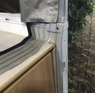 Cut magnetic fly screen from bottom of caravan flush with cupboard edge